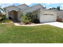 Inviting single-story home with a well-manicured lawn and charming curb appeal at 236 Ridge View Dr, Davenport, FL 33837