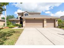 Charming two-story home with a three car garage and a well maintained front yard at 341 Kirkhill St, Ocoee, FL 34761