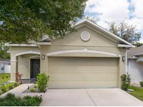 Charming home featuring a two-car garage, manicured landscaping, and classic architectural details at 116 Hurst Ct, Deland, FL 32724