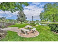 Inviting backyard with a stone picnic table and peaceful lake view, perfect for outdoor dining and relaxation at 1329 Maury Rd, Orlando, FL 32804