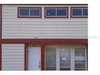 Charming home exterior with white siding, red trim, and well-placed windows at 1826 Warringwood Dr # B-1, Orlando, FL 32839