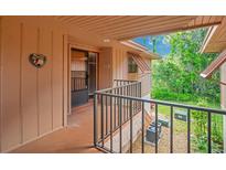 Inviting entrance with welcome sign and covered porch and unit number, creating a cozy ambiance at 190 Hickory Woods Ct # 12B, Deltona, FL 32725