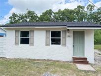 Charming home featuring a tidy front lawn, updated windows with classic shutters and a freshly painted front door at 1921 Nw 12Th St, Ocala, FL 34475