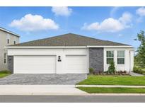 Charming single-Gathering home features a three-car garage, stone accents, and manicured landscaping at 2152 Rock Maple Bnd, Kissimmee, FL 34746