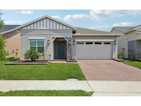 Charming single Gathering home featuring a well-manicured lawn and attached two-car garage at 2905 Tupelo Loop, St Cloud, FL 34772