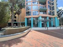 Beautiful condominium building with a water feature and towering palm trees enhancing the curb appeal at 322 E Central Blvd # 908, Orlando, FL 32801