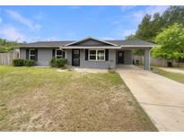 Charming home featuring a covered portico and freshly painted exterior with dark shutters at 6740 Se 107Th St, Belleview, FL 34420