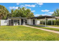 Charming single-story home featuring a well-manicured lawn and convenient carport at 843 W Swoope Ave, Winter Park, FL 32789