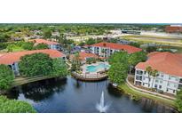An aerial view of a condo community with a pool and pond with fountain feature at 2549 Maitland Crossing Way # 306, Orlando, FL 32810