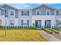 Inviting exterior of a charming townhome with a well-manicured lawn and a welcoming entrance at 3729 Pacific Ln, Davenport, FL 33897