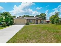 Charming one-story home with a well-manicured lawn and a long driveway at 936 Dandridge Dr, Deltona, FL 32725