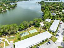 Aerial view of community featuring a lake, lush landscaping, and on-site amenities at 1140 S Orlando Ave # E-1, Maitland, FL 32751