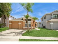 Charming single-story home featuring a well-manicured lawn and a two-car garage at 1413 Timberbend Cir, Orlando, FL 32824