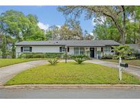 Charming home featuring a well-manicured lawn and a circular driveway, adding to its curb appeal at 1621 Highland Dr, Longwood, FL 32750