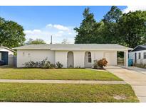 Charming single-story home featuring a well-maintained lawn and unique architectural details and covered parking at 4246 Clarinda St, Orlando, FL 32811