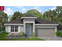 Charming single-story home with a two-car garage, neutral stucco, and an inviting front yard with fresh landscaping at 2030 Firethorn Loop, Haines City, FL 33844