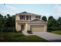 Inviting two-story home with a two-car garage, neutral color palette, and lush green landscaping at 2803 San Marco Way, Winter Haven, FL 33884