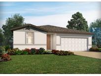 Charming single-story home featuring a well-manicured lawn, flowering bushes, and an attached two-car garage at 2928 Wild Olive Dr, St Cloud, FL 34772