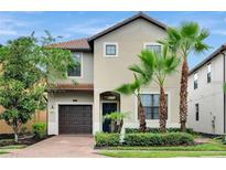 Charming two-story home featuring a tile roof, stucco exterior, and well-manicured landscaping at 5416 Solterra Cir, Davenport, FL 33837