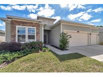 Charming single-Gathering home with a two-car garage and beautifully landscaped front yard at 7563 Sw 78Th Ter, Ocala, FL 34481