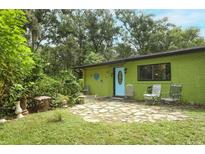 Inviting exterior view with lush landscaping, stone patio, and charming curb appeal at 7761 Hillcrest Ter, Orlando, FL 32810