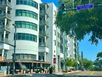 Modern condominium building featuring multiple stories, balconies, and street-level retail space at 10 N Summerlin Ave # 25, Orlando, FL 32801