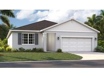 Charming single-Gathering home with a two-car garage, well-maintained lawn, and beautiful landscaping at 1712 Blue Lagoon Cir, Mascotte, FL 34753