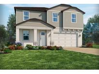 Charming two-story home featuring a manicured lawn and a two-car garage at 2240 Hen Rd, Minneola, FL 34715