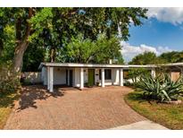 Charming single story home with a brick driveway, covered porch and a beautifully maintained front yard at 3425 N Westmoreland Dr, Orlando, FL 32804