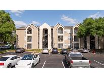 Inviting three-story apartment building with exterior staircase and ample parking at 4708 Walden Cir # 37, Orlando, FL 32811