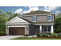 Charming two-story home featuring a two-car garage and classic architectural details at 557 Moon Shell Cir, New Smyrna Beach, FL 32168