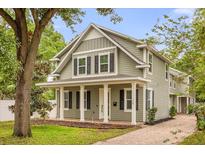 Charming two-story home featuring a cozy front porch with brick pavers and white columns at 730 Cordova Dr, Orlando, FL 32804