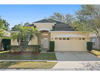 Charming single-story home with well-maintained landscaping and a two-car garage at 9723 Pecky Cypress Way, Orlando, FL 32836
