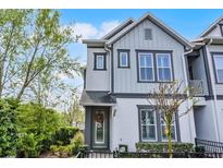 Attractive two-story townhome with gray and white exterior, well-maintained landscaping, and inviting entrance at 1010 Lychee Ct, Lake Mary, FL 32746