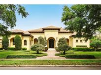 Stunning Mediterranean home with manicured landscaping and a tile roof at 11055 Ullswater Ln, Windermere, FL 34786