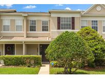 Two-story home with neutral exterior paint, attractive landscaping, and well-maintained lawn at 1530 Tally Cir, Oviedo, FL 32765