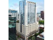 Contemporary high-rise condo building showcasing modern architecture and glass facade at 155 S Court Ave # 1202, Orlando, FL 32801