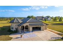 Charming home with a three car garage, and a beautiful tile roof, on a well-manicured lot at 20951 County Road 561, Clermont, FL 34715