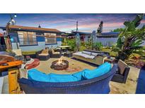 Outdoor patio with fire pit, comfortable seating and mature landscaping at 340 Zelda Blvd, Daytona Beach, FL 32118