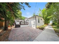 Charming bungalow with brick patio and small porch in front yard at 506 S Hyer Ave, Orlando, FL 32801