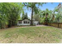 Charming single-story home with lush greenery, landscaping, and a brick walkway leading to the front entrance at 506 S Hyer Ave, Orlando, FL 32801