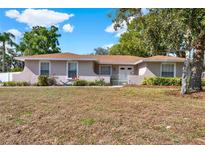 Charming single-story home featuring a well-maintained lawn and mature trees on a sunny day at 650 Sweetbriar Br, Longwood, FL 32750