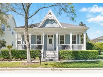 Charming home with inviting porch, decorative gable, and well-maintained landscaping at 931 Croton Rd, Celebration, FL 34747