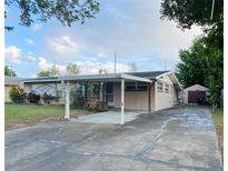 Charming single-story home featuring a covered carport and well-maintained front yard at 1118 Arrowsmith Ave, Orlando, FL 32809