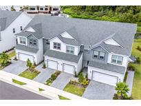An aerial view displays these modern townhomes with two-car garages and manicured landscaping at 1438 Brookdale Ct, Oviedo, FL 32765