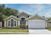 Charming single-Gathering home showcases a well-manicured lawn and an attached two-car garage at 4404 Gwyndale Ct, Orlando, FL 32837