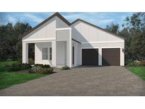 Charming single-story home showcasing a two-car garage and beautifully landscaped front yard at 5236 Citrus Leaf Blvd, Winter Garden, FL 34787