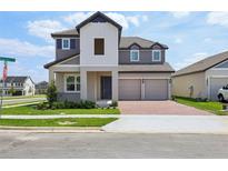 Charming two-story home with a two-car garage, manicured lawn, and a welcoming front porch at 5278 Citrus Leaf Blvd, Winter Garden, FL 34787
