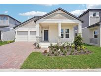 Charming single-story home with a manicured front yard, welcoming porch, and a two car garage at 5290 Citrus Leaf Blvd, Winter Garden, FL 34787