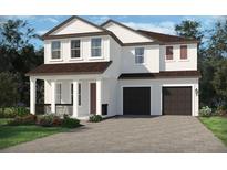 Charming two-story home with white siding, a covered porch, and a two-car garage at 5319 Citrus Leaf Blvd, Winter Garden, FL 34787